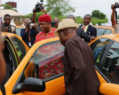 Gov. Theodore Orji of Abia state inspecting some of the 200 vehicles procured for the 2014 youth empowerment programme of Arochukwu, Ohafia and Bende at Bende Local Government headquaters in Bende LGA. with him is his deputy Sir Emeka Ananaba.