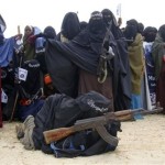 Somali women carry weapons during a demonstration in Suqa Holaha neighborhood in Mogadishu, Somalia, Monday, July 5, 2010. The demonstration was organized by the islamist