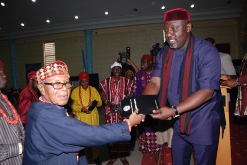 Gov Rochas Okorocha present a copy of the Imo Security Black File to HRm Eze Emmanuel Njemanze during the occasion at Owerri recently