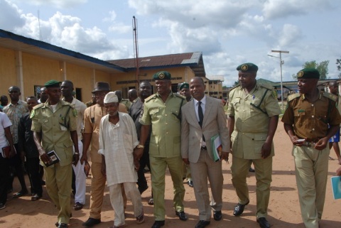 Mr Canice Egbunanne, a prisoner and a 94 years old man who was granted pardon by Owelle Rochas Okorocha during the 54th independence Anniversary is being led out by some Federal Prisons officials in Owerri recently