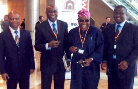 Dimgba Igwe [left] with colleagues. Folu Olamiti [in traditional garb]