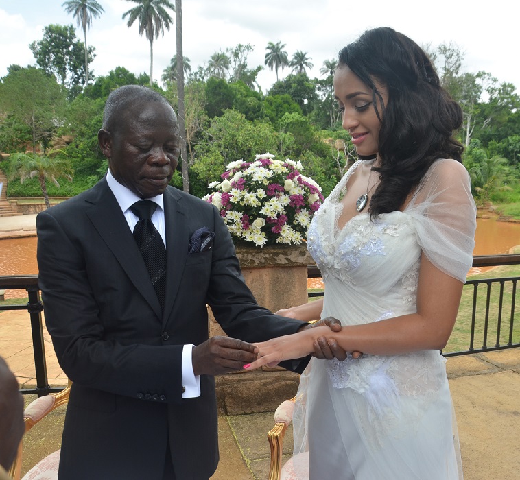 Governor Adams Oshiomhole slips puts a ring on the finger of fomer Miss Iara Fortes at a private marriage registry at Iyamho, Etsako West Local Government Area of Edo State, on Friday