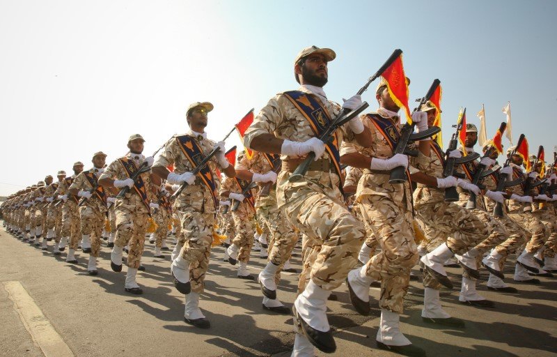 Members of Iranian revolutionary guard march during parade to commemorate anniversary of Iran-Iraq war, in Tehran