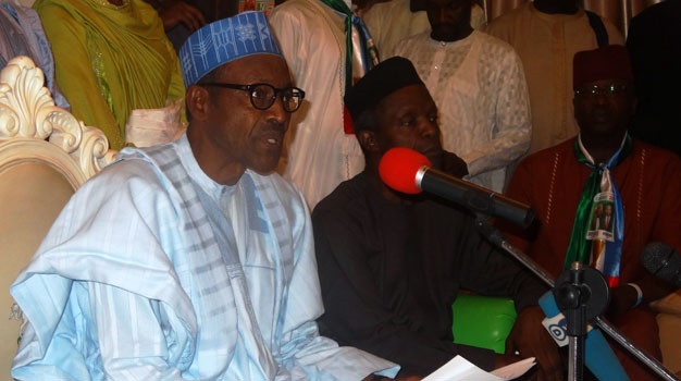 Presidential candidate of the All Progressives Congress (APC) and former army general Muhammadu Buhari (L) speaks during a press conference in Kano, northern Nigeria, on January 21, 2015. Nigeria's main opposition candidate today rejected claims about his eligibility to run for president, accusing the ruling party of trying to divert attention from its own failings. The February 14 vote is expected to be close-run, with the possibility of the PDP being dumped out of power for the first time since Nigeria returned to civilian rule in 1999.  AFP PHOTO / AMINU ABUBAKAR