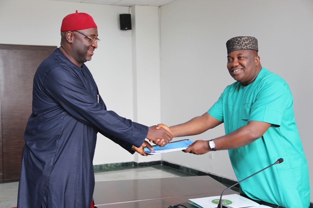 Governor Ifeanyi Ugwuanyi of Enugu State, (right) receiving the report of the panel on staff audit and bio metric capture of 17 local government councils in the state from the chairman and Speaker of the state House of Assembly, Hon. Edward Ubosi when the committee presented its report at Government House, Enugu, yesterday.