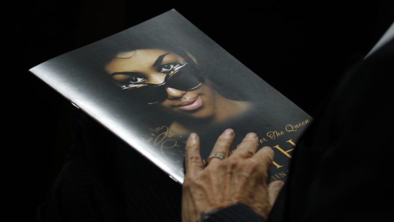 A person holds a program during the funeral service for Aretha Franklin.