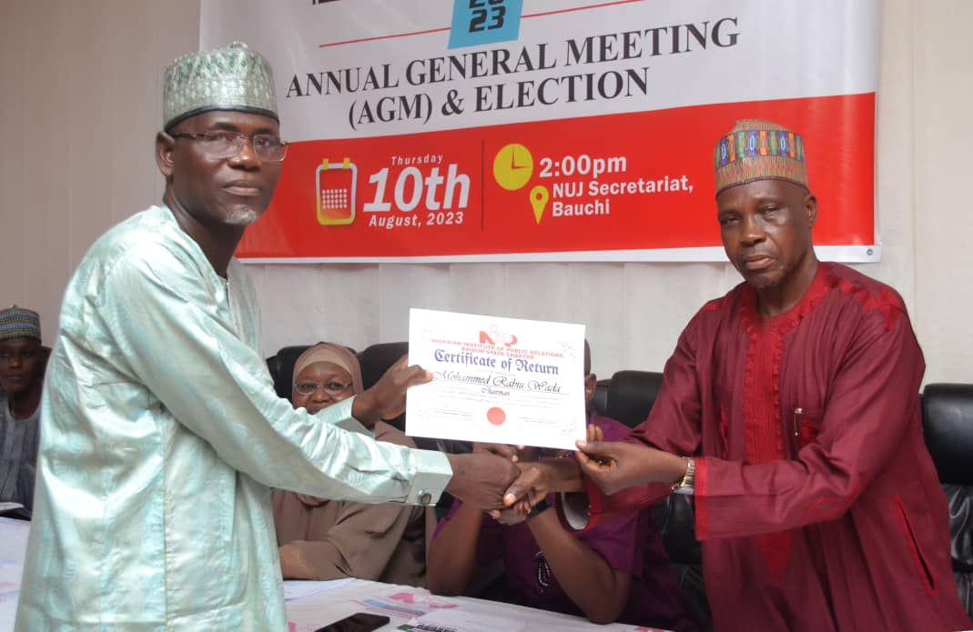 L-R Newly elected Chairman of NIPR, Malam Mohammed Rabiu Wada and Mr Inuwa Bello, presenting his certificate of election by Chairman Elders Advisory Council of the Chapter